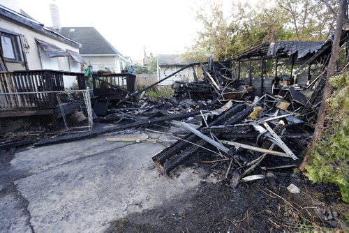 LOCAL  Overnight , Garage Fire 200 block of Hampton St in St. James destroyed garage and rear of the house . Aug 28 2014 / KEN GIGLIOTTI / WINNIPEG FREE PRESS