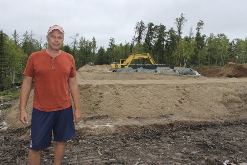 01 - Warren Froese overlooks sewer and water treatment plants under construction across from the family cottage at Brereton Lake.  BILL REDEKOP/WINNIPEG FREE PRESS Aug 28,2014