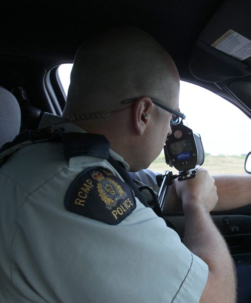 RCMP CPL Mark Hume  during traffic enforcement on Hyw #1 near Portage La Prairie  he uses lazer speed gun  See Mary Agnes Welch  story- Aug 08, 2014   (JOE BRYKSA / WINNIPEG FREE PRESS)
