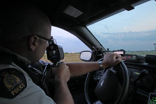 RCMP CPL Mark Hume  during traffic enforcement on Hyw #1 near Portage La Prairie  he uses lazer speed gun  See Mary Agnes Welch  story- Aug 08, 2014   (JOE BRYKSA / WINNIPEG FREE PRESS)