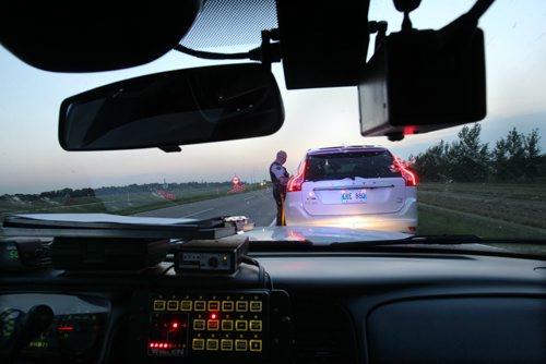 RCMP CPL Mark Hume  during traffic enforcement on Hyw #1 near Portage La Prairie talks with driver after being caught for speeding  See Mary Agnes Welch  story- Aug 08, 2014   (JOE BRYKSA / WINNIPEG FREE PRESS)