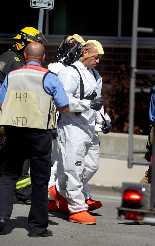 Haz-Mat garbed firefighters prepare to enter the Canadian Blood Services building on Willam ave Thursday afternoon. THe building was evacuated for about 2 hrs while something was cleaned up inside. See story. August 28, 2014 - (Phil Hossack / Winnipeg Free Press)