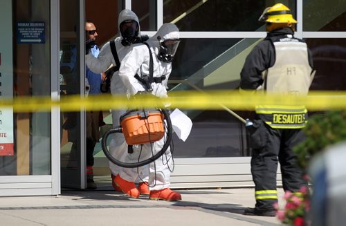 Haz-Mat garbed firefighters exit to enter the Canadian Blood Services building on Willam ave Thursday afternoon. The building was evacuated for about 2 hrs while something was cleaned up inside. See story. August 28, 2014 - (Phil Hossack / Winnipeg Free Press)