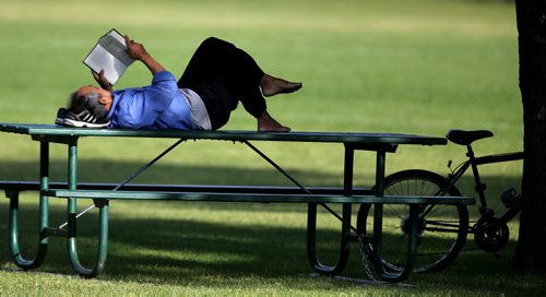 Assan Alizadeh rinds a spot to read in St.Vital Park, Thursday, August 28, 2014. (TREVOR HAGAN/WINNIPEG FREE PRESS)