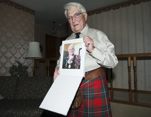 Tony Grogan holds a photo of himself fully dressed in his full Scottish attire in his Teulon home. Grogan came here from Scotland over thirty years ago and weighs in on his homeland's possible independence. Sarah Taylor / Winnipeg Free Press August 28, 2014 Adam Wazny story