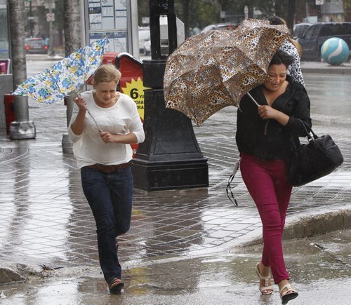 The weather was  windy and wet for pedestrians on Portage Ave. Friday. Wayne Glowacki/Winnipeg Free Press August 29 2014
