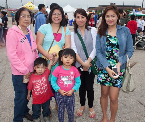 The third annual Manitoba Filipino Street Festival included a colourful parade that ended at Garden City Shopping Centre, where the festival offered entertainment on the mainstage. Pictured (from left) are Filomena Santiago, Dominic Mari, Mary Jane Mari, Mikayla Mari, Maureen Reyes and Ael Joson. (John Johnston / Winnipeg Free Press)