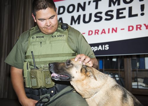 Natural resource officer Chad Moir and canine-unit member Fauna at the Legislative Building on Friday as the province announces Don't Move A Mussel update and how the canine unit will assist with monitoring zebra mussels in Manitoba's lakes. Sarah Taylor / Winnipeg Free Press August 29, 2014