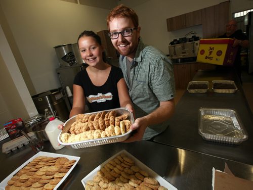 Joel Cormie of Lighthouse Mission on Main street poses with Reese Precourt who baked cookies raising funds towards the soup kitchen's kitchen renovations. See Ashely Prest story.  August 29, 2014 - (Phil Hossack / Winnipeg Free Press)