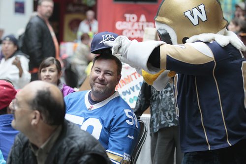August 31, 2014 - 140825  - Buzz jokes around with a fan as he gets about thirty Winnipeg Blue Bomber fans in the mood for the Labour Day Classic at The Forks, Sunday, August 31, 2014.  John Woods / Winnipeg Free Press