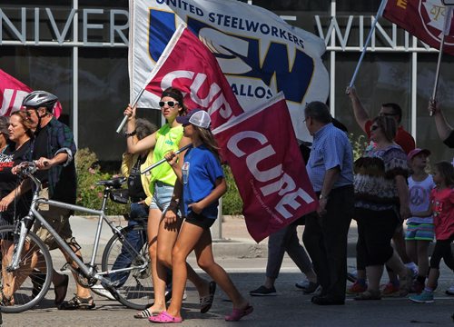 Union members walk along Memorial Blvd and Portage Avenue towards Vimy Ridge Park during the annual Labour Day March.  140901 September 01, 2014 Mike Deal / Winnipeg Free Press