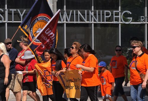 Union members walk along Memorial Blvd and Portage Avenue towards Vimy Ridge Park during the annual Labour Day March.  140901 September 01, 2014 Mike Deal / Winnipeg Free Press