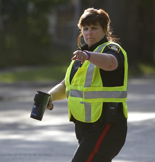 Winnipeg Police Const. Karen McCowan pulls another motorist over on McDermot Ave. that was execeding the 30km. speed zone near Ecole Sacre Coeur School Tuesday morning. Most of the drivers were given warnings to try educate them of the new school zone speeds that took effect Sept.1 7A.M.-5:30P.M.    Wayne Glowacki/Winnipeg Free Press Sept.2 2014