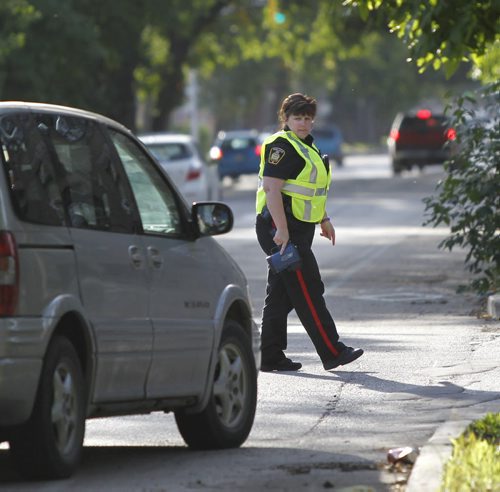 Winnipeg Police Const. Karen McCowan pulls another motorist over on McDermot Ave. that was execeding the 30km. speed zone near Ecole Sacre Coeur School Tuesday morning. Most of the drivers were given warnings to try educate them of the new school zone speeds that took effect Sept.1 7A.M.-5:30P.M.    Wayne Glowacki/Winnipeg Free Press Sept.2 2014