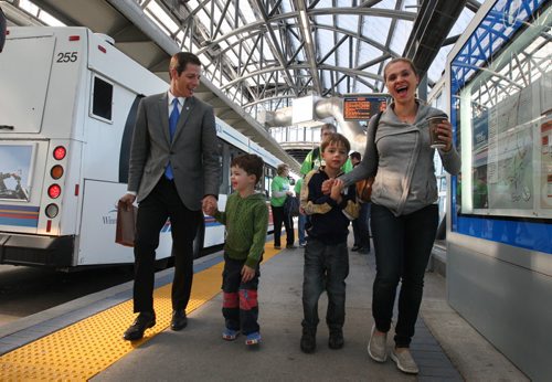 Brian Bowman arrives on a bus at the Rapid Transit Osborne station with his family- his wife Tracy, and his two sons, Austin, left, and Hayden Tuesday morning He announced today outside the station that if he was elected mayor he would get  all phases of Rapid Transit completed in Winnipeg by 2030- See Bartley Kives story- Sept 02, 2014   (JOE BRYKSA / WINNIPEG FREE PRESS)