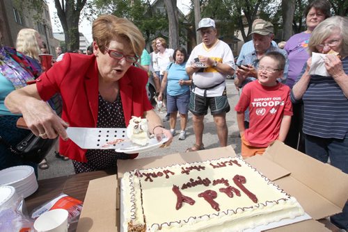 Mayoral candidate Judy Wasylycia-Leis  cuts a campaign cake outside her campaign office on Portage Ave Tuesday afternoon after her announcement today- Standup Photo- Sept 02, 2014   (JOE BRYKSA / WINNIPEG FREE PRESS)