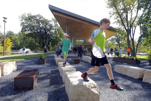 Opening of the St. Vital Park Duck Pond Pavilion and Écobuage public art project. Wells Mayes,10, and Ben Mayes, 9, play on the new facilities. BORIS MINKEVICH / WINNIPEG FREE PRESS  Sept. 2, 2014