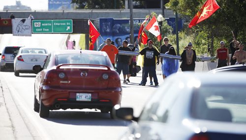 September 2, 2014 - 140902  -  People block two lanes of rush-hour traffic on Portage Ave at Strathcona St in Winnipeg Tuesday, September 2, 2014.  John Woods / Winnipeg Free Press