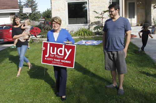 Mayoral candidate  Judy Wasylycia-Leis announced Wednesday her campaign has now installed 1,500 lawn signs in Winnipeg like the one in front of the Delisle family home in Charleswood. From left, Pamela holds Milla and John with son Oscar.  Wayne Glowacki/Winnipeg Free Press Sept.3 2014