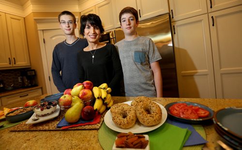 Gina Sunderland, a registered dietitian, and her sons, Reid, 17, and Joel, 15, with healthy breakfast foods, Wednesday, September 3, 2014. (TREVOR HAGAN/WINNIPEG FREE PRESS)