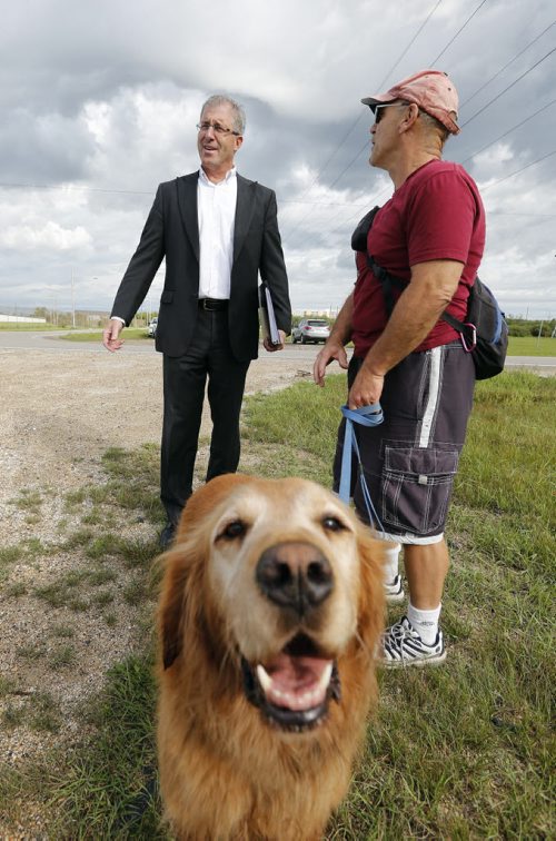 Gord Steeves talks with dog owner Robert Bagmercy with his dogTucker on Parker lands  near dog park before his newser.Mayor Candidate Gord Steeves challenges  Judy Wasylycia -Leis  BRT  financing at a news cofrence  held  on the Parker Lands  an area that may be used for the BRT .  SEPT  4 2014 / KEN GIGLIOTTI / WINNIPEG FREE PRESS