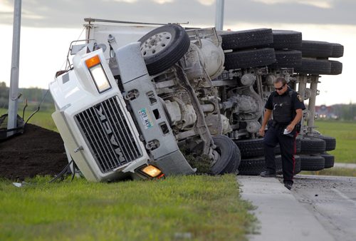 LOCAL - A semmi hauling dirt flipped over at the intersection of Lagimodière Blvd & Chief Peguis Trail. No report on any injuries. Winnipeg Police on scene. BORIS MINKEVICH / WINNIPEG FREE PRESS  Sept. 4 2014