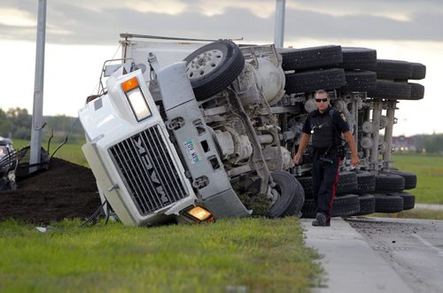 LOCAL - A semmi hauling dirt flipped over at the intersection of Lagimodière Blvd & Chief Peguis Trail. No report on any injuries. Winnipeg Police on scene. BORIS MINKEVICH / WINNIPEG FREE PRESS  Sept. 4 2014