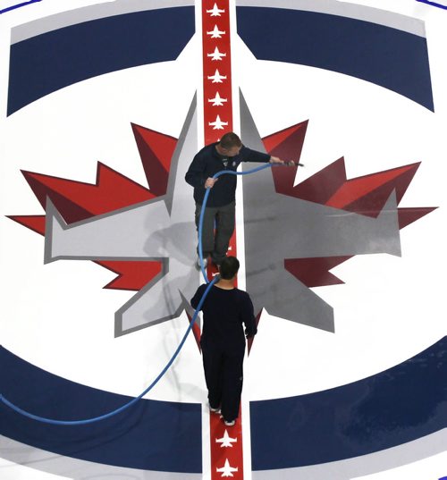 Seasonal Sight- The ice crew at the MTS Centre lay down a fresh Winnipeg Jets logo Thursday afternoon- The Jets have their home opener Oct 17, 2014 against the Nashville Predators-Standup Photo- Sept 04, 2014   (JOE BRYKSA / WINNIPEG FREE PRESS)