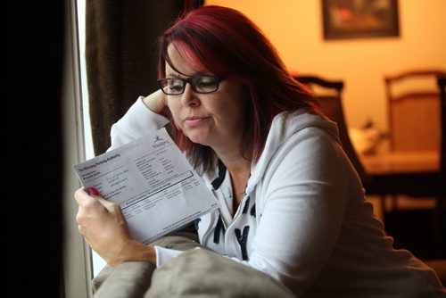 Angela Ives is dismayed after receiving notice in mail to pay for two parking tickets; one issued in 1998, one in 1999 sent to her from Winnipeg parking authority.  See Story. Sept 04.  2014 Ruth Bonneville / Winnipeg Free Press   Ruth Bonnevilles