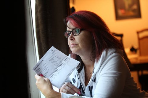 Angela Ives is dismayed after receiving notice in mail to pay for two parking tickets; one issued in 1998, one in 1999 sent to her from Winnipeg parking authority.  See Story. Sept 04.  2014 Ruth Bonneville / Winnipeg Free Press   Ruth Bonnevilles