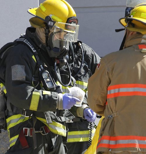 Members of the Winnipeg Fire Fighters Hazardous Material Response unit with substance that was inside the Pembina Chrysler dealership at 300 Pembina Hwy.Crews were called to Pembina Dodge Chrysler about 11:30 a.m. after reports of a package containing a powder had been opened by a staff member. Geoff Kirbyson story  Wayne Glowacki/Winnipeg Free Press Sept.5 2014