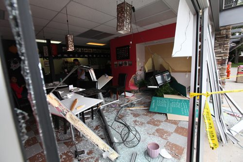 Kyungjae Lee, owner of Sushi Kudara, describes how she was setting a table in her restaurant on Academy seconds before a car came smashing through the window Saturday afternoon.  Fortunately no one was injured in the accident.  See Mary Agnes Story.   Sept 04.  2014 Ruth Bonneville / Winnipeg Free Press   Ruth Bonnevilles