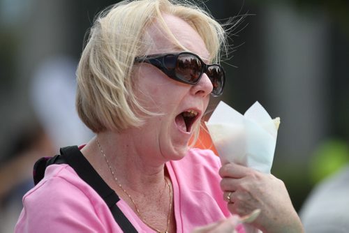 Christine Baumer enjoys a crepe filled with fruit and cream cheese on Broadway during ManyFest Saturday afternoon.    Sept 04.  2014 Ruth Bonneville / Winnipeg Free Press   Ruth Bonnevilles