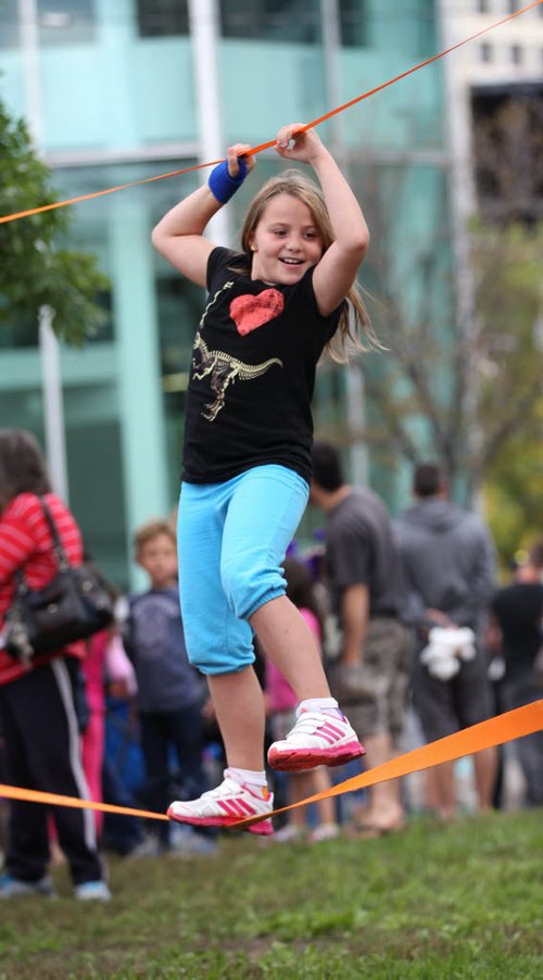 Nine-year-old Mackayla Taylor walks the tight rope set up along Broadway in the kids play zone at ManyFest Saturday afternoon.    Sept 04.  2014 Ruth Bonneville / Winnipeg Free Press   Ruth Bonnevilles