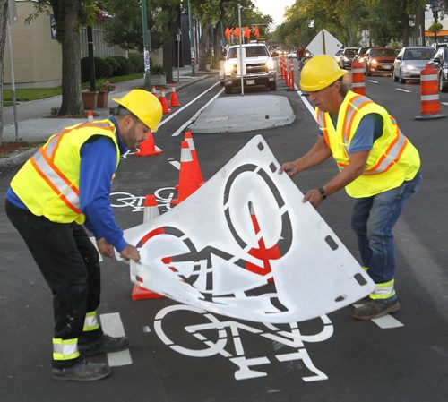 Members of the City of Winnipeg Traffic Services dept. were out stencilling Monday morning the new  parking-protected section of the dedicated bike lane on Sherbrook Street. This is part of the bilke lane  that will run north from the Maryland Bridge to Cumberland Avenue.  The parking-protected section for cyclists is  a stretch of lane that will feature a row of parked cars serving as a physical divide between riders and traffic. This is widely considered a trial project for lanes of this kind in the city.   Wayne Glowacki/Winnipeg Free Press Sept.8 2014
