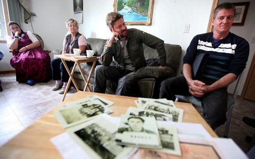 Left to right Shirley Maendel, Marianne Markus (daughter), Marcel Beranek (grandson) and Lutz Beranek (son of) second world war German POW Richard Beranek seen behind a table of snapshots taken at various Canadian POW camps he was held in. See Bill Redekop story re his family following his trail here in Canada.  September 9,2014 - (Phil Hossack / Winnipeg Free Press)