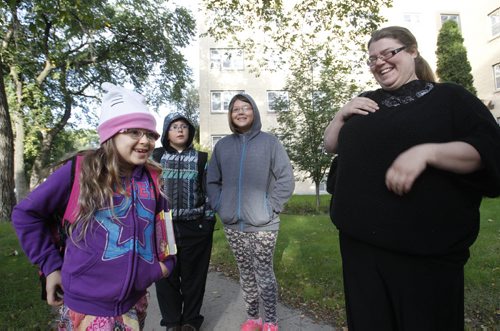 Corinna Cardamone with her niece Axanna walk her two children from left Adrianna and Furrio  to Mulvey School as police monitor the speed in the school zone along Wolseley Ave. Wednesday morning. Carol Sanders story Wayne Glowacki/Winnipeg Free Press Sept.10 2014