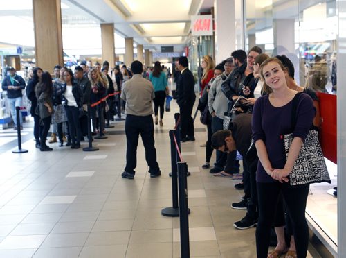 At right, Mallory Apter was first in line and moments away from getting into the new H&M store in the Polo Park Shopping Centre Wednesday morning. Geoff Kirbyson story Wayne Glowacki/Winnipeg Free Press Sept.10 2014