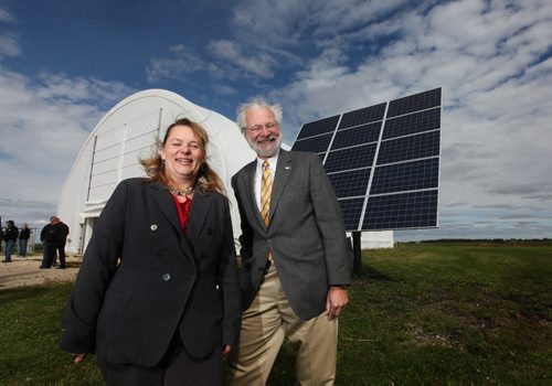 BASI, Bouyabnt Aircraft Systems President - Barry Prentice poses with Lorena Mitchell, President, EvolveGreen.CA next to a new solar system that was installed at BASI Airdock hangar, the first hangar at any Canadian airport that is using solar energy to operate.  See Martin Cash story.  Sept 10.  2014 Ruth Bonneville / Winnipeg Free Press   Ruth Bonnevilles