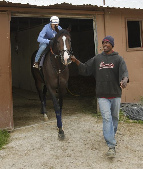 Groom Vaughan Taylor brings  Magic D'Oro with Jockey Alyssa Harder out of the barn for workout at the Assiniboia Downs Thursday morning. George Williams story Wayne Glowacki/Winnipeg Free Press Sept.11 2014