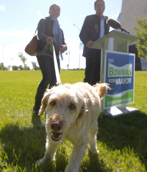 Brian Bowman, his wife Tracy and his dog Indiana at a press announcement in the park on the Red River across the street from the new Human Rights Museum. BORIS MINKEVICH / WINNIPEG FREE PRESS  Sept. 12, 2014