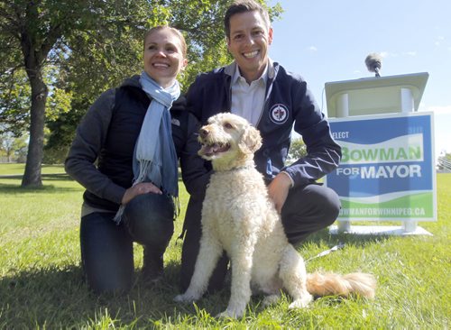 Brian Bowman, his wife Tracy and his dog Indiana at a press announcement in the park on the Red River across the street from the new Human Rights Museum. BORIS MINKEVICH / WINNIPEG FREE PRESS  Sept. 12, 2014