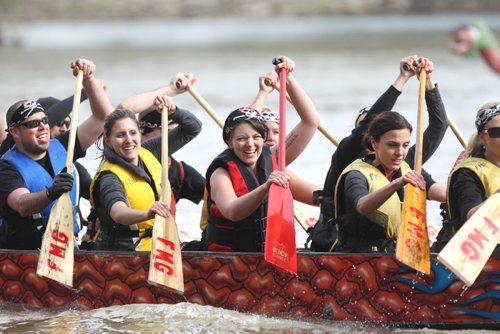 A Dragon Boat team rowers are all smiles after winning their heat at the FMG annual Manitoba Dragon Boat Races Saturday at the Forks.  Funds raised go to CancerCare Manitoba. Standup Sept 13,  2014 Ruth Bonneville / Winnipeg Free Press