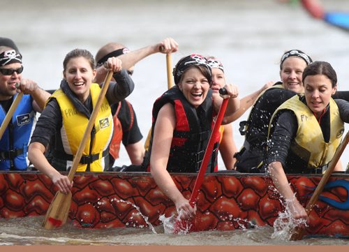 Dragon Boat team rowers called the Shipwrecks (names from left - Marc Sabouin, Esther Hawn, Kristina Mayor (in red) and Amanda Nash, are all smiles after winning their heat at the FMG annual Manitoba Dragon Boat Races Saturday at the Forks.  Funds raised go to CancerCare Manitoba. Standup Sept 13,  2014 Ruth Bonneville / Winnipeg Free Press