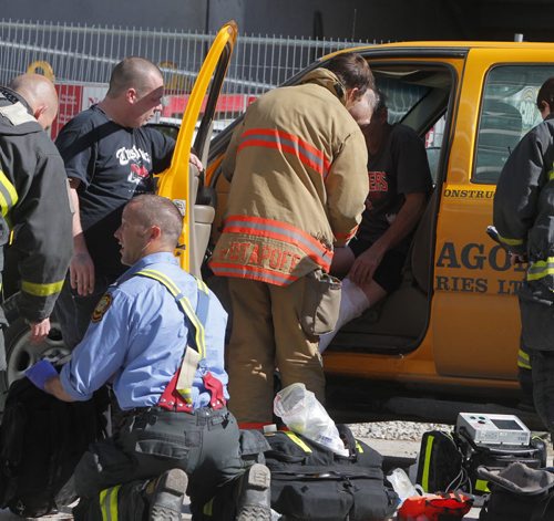 An explosion on the construction site where the new Glass House project sent one worker to hospital with non life threatening injuries. Here fire paramedics with victim. BORIS MINKEVICH / WINNIPEG FREE PRESS  Sept. 15, 2014