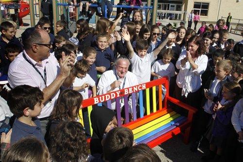 At the unveiling Monday, substitute teacher Morris Henoch (centre, behind bench) along with students and staff at Gray Academy of Jewish Education celebrate their new Buddy Bench. Morris saw a story about Christian Buck, a grade 2 student who saw a problem in his elementary school in the state of New York and had the idea of the Buddy Bench for others to see the students that wanted to be invited and included in a recess activity. Morris sanded and painted one of the school's wooden benches to create an "oasis or refuge" and as a tool to educate the students the importance of inclusion. The goal by spring is no one will be sitting on the bench, everyone is included. Wayne Glowacki/Winnipeg Free Press Sept.15 2014