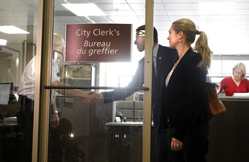 Brian Bowman with his wife Tracy shakes the hand of a member of the security staff as they leave the  City Clerk's office Monday after filing his mayoral nomination papers Monday.   Wayne Glowacki/Winnipeg Free Press Sept.15  2014