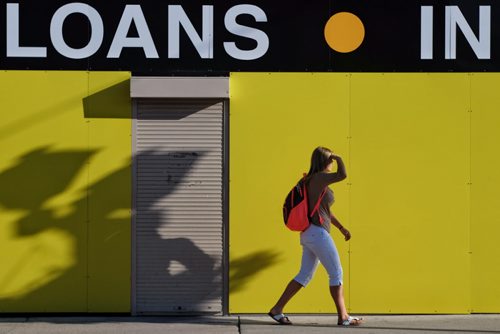 A pedestrian shades her eyes from the bright sun while walking along Elice Avenue Tuesday morning.  140916 September 16, 2014 Mike Deal / Winnipeg Free Press