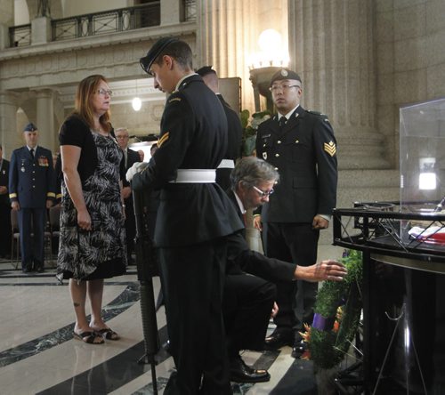 Keith and Penny Greenfield who lost their son Sean David Greenfield,25, when the armoured vehicle he was inside in 2009 struck a roadside bomb in the volatile Zhari place a wreath behalf of the Families of the Fallen at a ceremony to open the  Afghanistan Memorial Vigil that will be on display at the Manitoba Legislative Building. The Vigil is built from the recovered memorial plaques from Kandahar Air Field cenotaph, the Vigil display focuses on fallen Canadians, including the 158 soldiers, a Canadian diplomat, contractor, journalist as well as 40 United States Armed Forces personnel attached to the Canadian Forces. Larry Kusch story Wayne Glowacki/Winnipeg Free Press Sept.16  2014