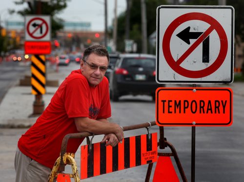 Geoff Hayden, co-owner of Brathwaites Pharmacy on Ness poses on the street in front of his store. Construction has been ongoing for some time. See Kevin Rollason's story. September 16, 2014 - (Phil Hossack / Winnipeg Free Press)